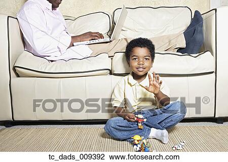 Young African American boy playing on floor View Large Photo Image Stock Image - Young African American boy playing on floor. Fotosearch