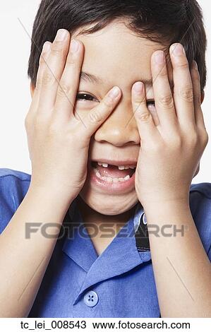 Young boy covering face with hands View Large Photo Image Stock Image - Young boy covering face with hands. Fotosearch
