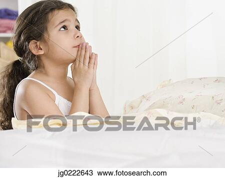 Young Hispanic girl saying bedtime prayers View Large Photo Image Stock Image - Young Hispanic girl saying bedtime prayers. Fotosearch