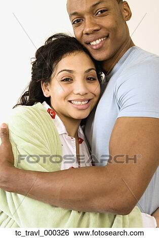 African couple hugging and smiling View Large Photo Image Stock Photograph - African couple hugging and smiling. Fotosearch