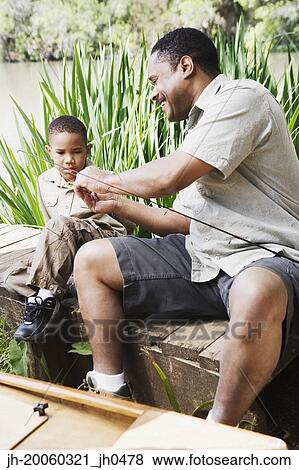 Stock Photo - African father and son with fishing gear. Fotosearch