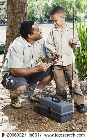 African father and son with fishing gear View Large Photo Image Stock Photo - African father and son with fishing gear. Fotosearch