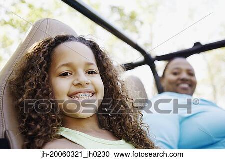 African mother and daughter sitting in jeep smiling View Large Photo Image Stock Image - African mother and daughter sitting in jeep smiling. Fotosearch