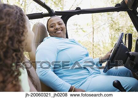 African mother and daughter sitting in jeep smiling View Large Photo Image Stock Photo - African mother and daughter sitting in jeep smiling. Fotosearch