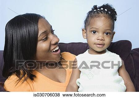 African mother and young daughter on sofa View Large Photo Image Stock Photo - African mother and young daughter on sofa. Fotosearch