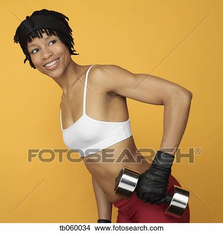 Picture - African woman lifting weights. Fotosearch