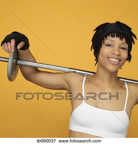 Stock Photo - African woman lifting weights. Fotosearch