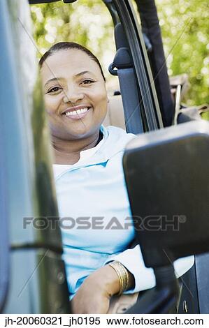 African woman sitting in jeep View Large Photo Image Stock Photography - African woman sitting in jeep. Fotosearch