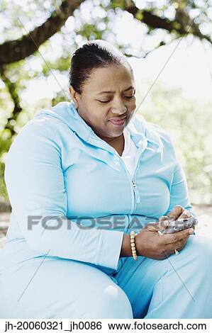 African woman using cell phone outdoors View Large Photo Image Stock Photograph - African woman using cell phone outdoors. Fotosearch