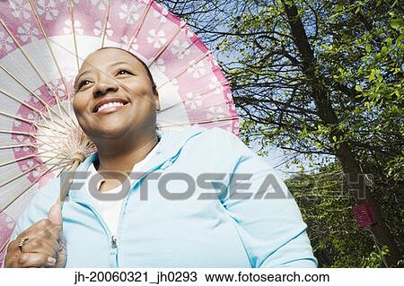 African woman with parasol outdoors View Large Photo Image Stock Image - African woman with parasol outdoors. Fotosearch