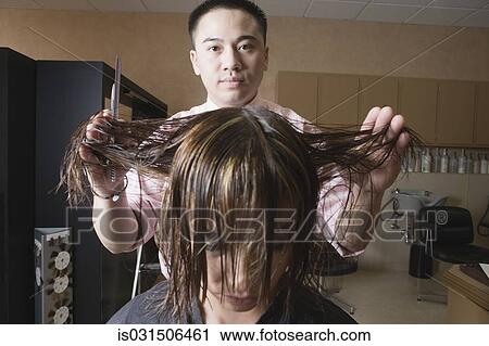 Asian male hairstylist cutting hair View Large Photo Image Stock Image - Asian male hairstylist cutting hair. Fotosearch