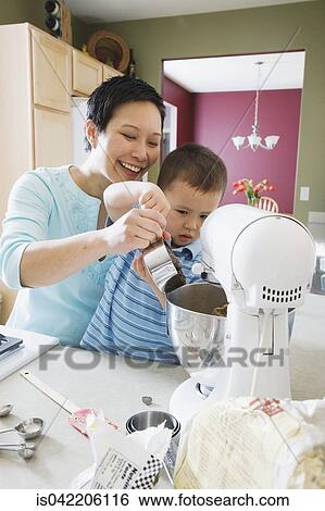 Asian mother and young son baking in kitchen View Large Photo Image Stock Photograph - Asian mother and young son baking in kitchen. Fotosearch