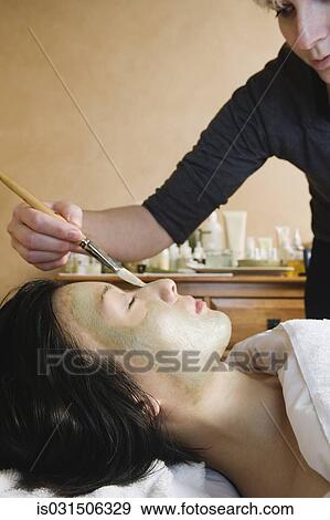 Asian woman receiving spa facial treatment View Large Photo Image Stock Photo - Asian woman receiving spa facial treatment. Fotosearch