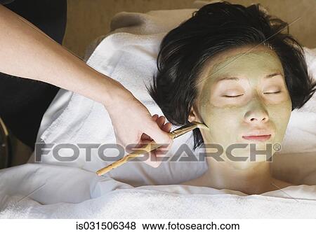 Asian woman receiving spa facial treatment View Large Photo Image Stock Photo - Asian woman receiving spa facial treatment. Fotosearch