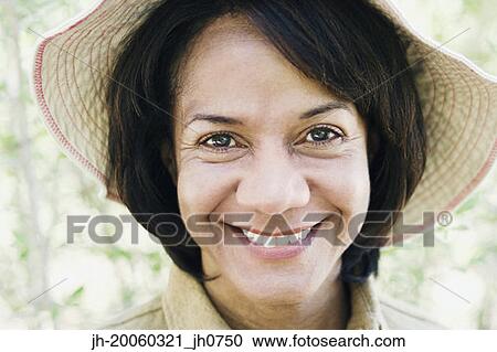Close up of African woman smiling and wearing hat View Large Photo Image Stock Image - Close up of African woman smiling and wearing hat. Fotosearch