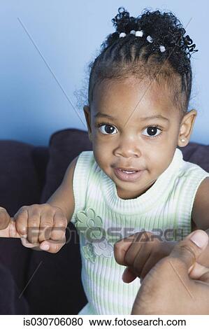 Stock Image - Close up of young African girl. Fotosearch