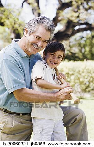 Father and son holding baseball bat View Large Photo Image Stock Photo - Father and son holding baseball bat . Fotosearch