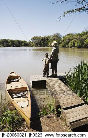 Father and son standing on dock View Large Photo Image Stock Image - Father and son standing on dock. Fotosearch