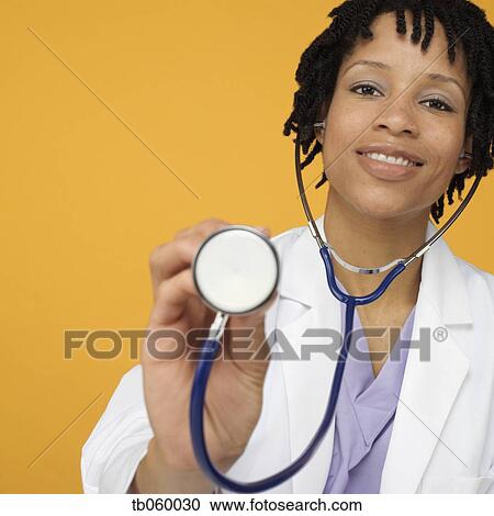 Stock Image - Female African doctor with stethoscope. Fotosearch