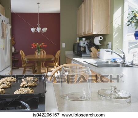 Fresh cookies next to empty cookie jar View Large Photo Image Stock Photo - Fresh cookies next to empty cookie jar. Fotosearch