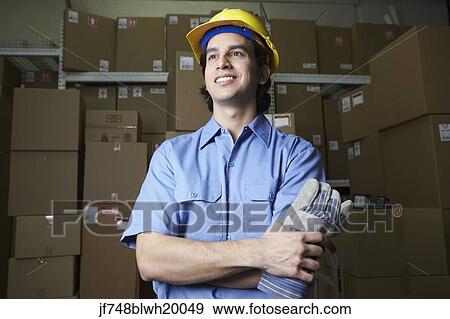 Hispanic male warehouse worker with boxes View Large Photo Image Stock Photo - Hispanic male warehouse worker with boxes. Fotosearch
