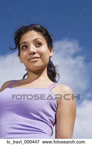 Low angle view of Hispanic woman outdoors View Large Photo Image Stock Photo - Low angle view of Hispanic woman outdoors. Fotosearch