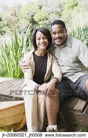 Middle-aged African couple smiling on dock View Large Photo Image Stock Photo - Middle-aged African couple smiling on dock. Fotosearch
