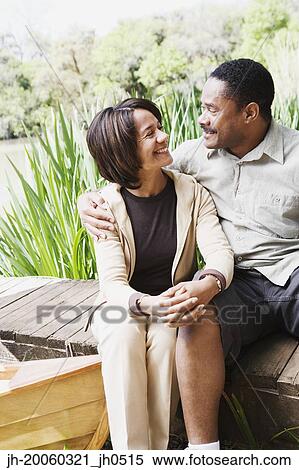Middle-aged African couple smiling on dock View Large Photo Image Stock Photography - Middle-aged African couple smiling on dock. Fotosearch