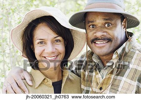 Middle-aged African couple smiling outdoors View Large Photo Image Stock Image - Middle-aged African couple smiling outdoors. Fotosearch