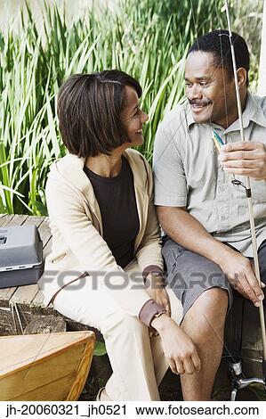 Middle-aged African couple smiling with fishing gear View Large Photo Image Stock Image - Middle-aged African couple smiling with fishing gear. Fotosearch