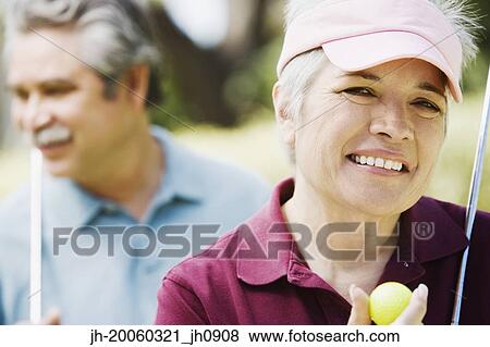 Middle-aged couple with golf clubs View Large Photo Image Stock Photo - Middle-aged couple with golf clubs. Fotosearch