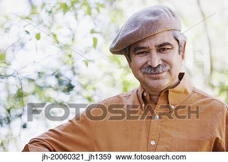 Middle-aged man wearing cap outdoors View Large Photo Image Stock Photo - Middle-aged man wearing cap outdoors. Fotosearch
