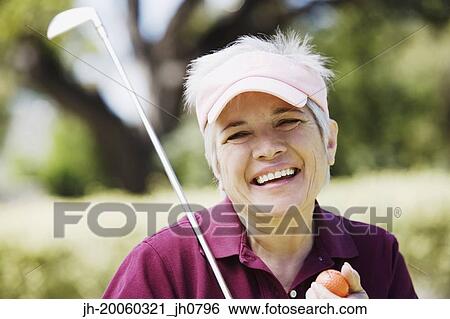 Middle-aged woman with golf club and golf ball View Large Photo Image Stock Photograph - Middle-aged woman with golf club and golf ball. Fotosearch