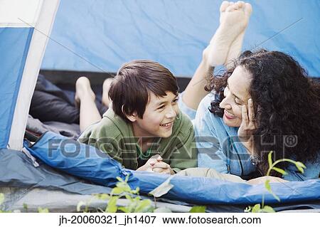 Mother and son laying in tent talking View Large Photo Image Stock Photo - Mother and son laying in tent talking. Fotosearch