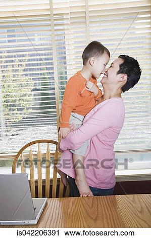 Pregnant mother and hugging young son View Large Photo Image Stock Image - Pregnant mother and hugging young son. Fotosearch