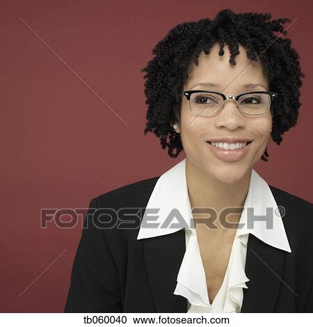 Stock Image - Studio shot of African businesswoman smiling. Fotosearch