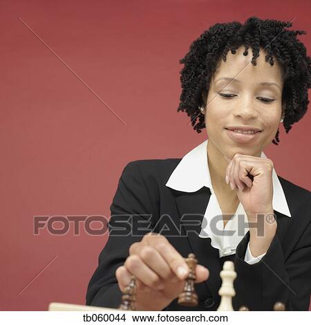 Picture - Studio shot of African woman playing chess. Fotosearch