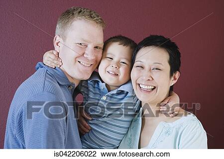 Studio shot of family with young son View Large Photo Image Stock Image - Studio shot of family with young son. Fotosearch
