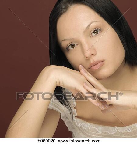 Studio shot of woman leaning face on hands View Large Photo Image Stock Image - Studio shot of woman leaning face on hands. Fotosearch