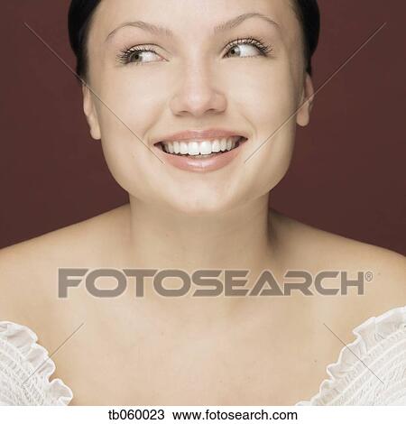 Studio shot of woman smiling View Large Photo Image Stock Image - Studio shot of woman smiling. Fotosearch
