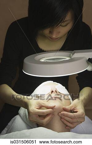 Woman receiving facial at spa View Large Photo Image Stock Image - Woman receiving facial at spa. Fotosearch