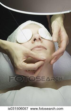 Stock Photo - Woman receiving facial at spa. Fotosearch