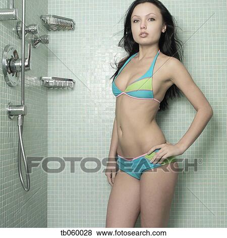 Stock Photo - Woman wearing bathing suit in shower. Fotosearch