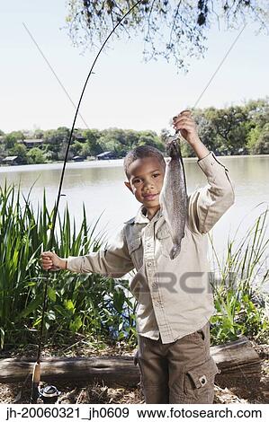 Young African boy with fishing pole and fish View Large Photo Image Stock Photo - Young African boy with fishing pole and fish. Fotosearch
