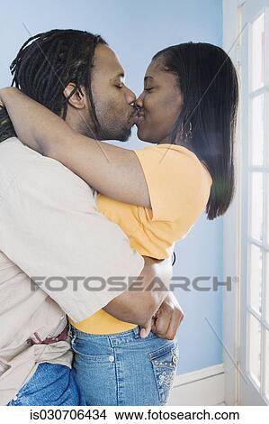 Young African couple hugging and kissing View Large Photo Image Picture - Young African couple hugging and kissing. Fotosearch