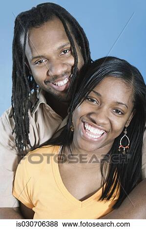 Young African couple hugging and smiling View Large Photo Image Stock Photo - Young African couple hugging and smiling. Fotosearch