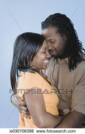 Young African couple hugging with eyes closed View Large Photo Image Stock Photo - Young African couple hugging with eyes closed. Fotosearch