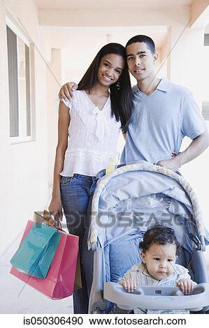 Young African couple with baby in stroller and shopping bags View Large Photo Image Stock Image - Young African couple with baby in stroller and shopping bags. Fotosearch