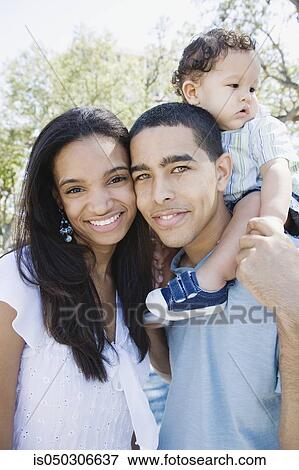 Young African couple with baby on shoulders View Large Photo Image Stock Photo - Young African couple with baby on shoulders. Fotosearch