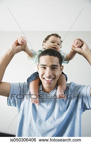 Stock Photograph - Young African father with baby on shoulders. Fotosearch